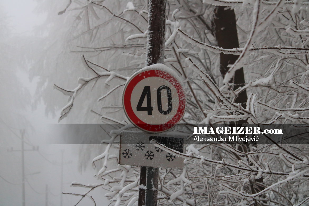 Speed limit sign covered by snow